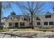 Lovely two-story white brick home with black shutters on a sunny day with a well-kept lawn at 357 Magnolia St, Davidson, NC 28036