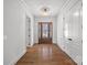 Elegant foyer with gleaming hardwood floors, chandelier lighting and a wood front door with glass inserts at 357 Magnolia St, Davidson, NC 28036