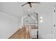 Upstairs hallway featuring hardwood floors, neutral paint, and a staircase with white railings at 357 Magnolia St, Davidson, NC 28036