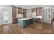 Modern kitchen with a large island, custom cabinetry, stainless steel appliances, and hardwood flooring at 357 Magnolia St, Davidson, NC 28036