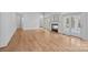 Expansive living room highlighting hardwood floors, a fireplace and French doors at 357 Magnolia St, Davidson, NC 28036