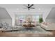 Bright living room featuring hardwood floors, comfortable seating, and natural light from multiple windows at 357 Magnolia St, Davidson, NC 28036