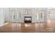 Bright living room featuring a marble fireplace, hardwood floors, and French doors leading to outdoor space at 357 Magnolia St, Davidson, NC 28036