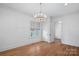 Bright, open living room featuring wood floors, a large window, and a modern chandelier at 357 Magnolia St, Davidson, NC 28036