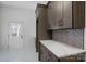 Walk-in pantry with lots of storage, marble countertop and stylish tile backsplash at 357 Magnolia St, Davidson, NC 28036