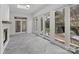 Bright sunroom with tile flooring, fireplace, and large sliding glass doors overlooking the backyard at 357 Magnolia St, Davidson, NC 28036