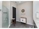 Modern bathroom featuring a glass-enclosed shower, a cabinet and a round mirror at 3630 N Davidson St # 4406, Charlotte, NC 28205