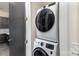 This laundry area features a stacked washer and dryer at 3630 N Davidson St # 4406, Charlotte, NC 28205