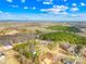 An aerial view of a residential area with tree coverage and mountain views in the distance at 4011 Brandy Creek Ct, Clover, SC 29710