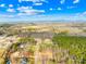 A high angle view shows a neighborhood nestled in a forest with blue skies at 4011 Brandy Creek Ct, Clover, SC 29710