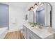 Modern bathroom featuring double sinks, chrome fixtures, and blue tiled walls at 4011 Brandy Creek Ct, Clover, SC 29710