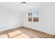 Bright bedroom featuring hardwood floors and a large window overlooking a wooded area at 4011 Brandy Creek Ct, Clover, SC 29710