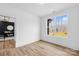 Minimalist bedroom with hardwood floors and a large window offering a view of the outdoor landscape at 4011 Brandy Creek Ct, Clover, SC 29710