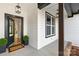 Inviting front porch with a stylish welcome mat, modern lighting and a glimpse of the home's interior at 4011 Brandy Creek Ct, Clover, SC 29710