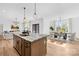 Bright kitchen with a kitchen island, seamlessly connected to the adjacent living and dining areas at 4011 Brandy Creek Ct, Clover, SC 29710