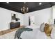 Comfortable main bedroom features dark ceiling, chandelier and decorative wall art at 4011 Brandy Creek Ct, Clover, SC 29710