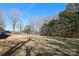 Backyard with trees and a partially visible house at 416 Delview Dr, Cherryville, NC 28021