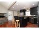 Modern kitchen with dark cabinetry, granite island, and stainless steel appliances at 416 Delview Dr, Cherryville, NC 28021