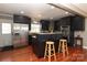 Modern kitchen with dark cabinetry, granite island, and stainless steel appliances at 416 Delview Dr, Cherryville, NC 28021