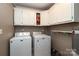 Laundry room with washer, dryer, and ample storage cabinets at 416 Delview Dr, Cherryville, NC 28021