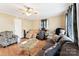 Cozy living room featuring hardwood floors, a ceiling fan, and comfortable seating with lots of natural light at 453 Bynum Ave, Rock Hill, SC 29732