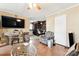 Open living room features hardwood floors, a ceiling fan, and lots of natural light with a view of dining area at 453 Bynum Ave, Rock Hill, SC 29732