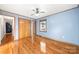 Light blue walls, hardwood floors, and door to hallway at 513 Paradise Cir, Belmont, NC 28012