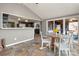 Sunlit dining area with tile floors, a wooden table, and views to the kitchen and deck at 513 Paradise Cir, Belmont, NC 28012