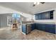 Modern kitchen with blue cabinets, tile floor, and breakfast nook at 513 Paradise Cir, Belmont, NC 28012