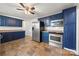 Kitchen with dark blue cabinets, stainless steel appliances, and tile flooring at 513 Paradise Cir, Belmont, NC 28012