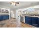 Spacious kitchen with blue cabinets, tile floors, and access to the deck at 513 Paradise Cir, Belmont, NC 28012