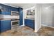 Kitchen features blue cabinets, tile floors and a pantry at 513 Paradise Cir, Belmont, NC 28012