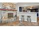 Stone fireplace with kitchen view, breakfast bar, and tile floors at 513 Paradise Cir, Belmont, NC 28012