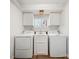 Laundry room with washer, dryer, and built-in cabinets at 513 Paradise Cir, Belmont, NC 28012