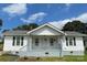 Charming white house with a front porch and well-maintained lawn at 516 Washington St, Cramerton, NC 28032