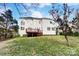 A lovely, green backyard featuring a deck and a two-story home at 561 Ambergate Nw Pl, Concord, NC 28027