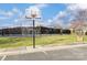 Community basketball court and tennis court are enclosed by a black chain-link fence at 561 Ambergate Nw Pl, Concord, NC 28027