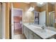 Bathroom with double sink vanity and large mirror at 561 Ambergate Nw Pl, Concord, NC 28027