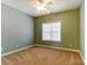 Bedroom with light green walls, carpeting, ceiling fan, and bright natural light from window at 561 Ambergate Nw Pl, Concord, NC 28027