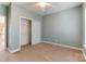 Cozy bedroom with closet, ceiling fan, and carpeted flooring at 561 Ambergate Nw Pl, Concord, NC 28027