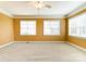 Light-filled bedroom with neutral walls, carpet, ceiling fan, and lots of natural light at 561 Ambergate Nw Pl, Concord, NC 28027