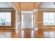 Bright foyer featuring hardwood floors, white door, and natural light streaming through the window at 561 Ambergate Nw Pl, Concord, NC 28027