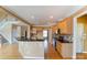 Kitchen with granite countertops, wooden cabinets and a view of the staircase at 561 Ambergate Nw Pl, Concord, NC 28027