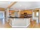 Kitchen island boasts granite countertops and wooden cabinetry, complementing the surrounding space at 561 Ambergate Nw Pl, Concord, NC 28027