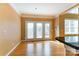 Bright living room boasts hardwood floors, neutral walls, and access to a private balcony at 561 Ambergate Nw Pl, Concord, NC 28027