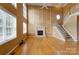 Living room with fireplace, high ceilings, hardwood floors, a ceiling fan, and staircase at 561 Ambergate Nw Pl, Concord, NC 28027