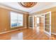 Inviting living room featuring hardwood floors, double doors, and an elegant ceiling medallion at 561 Ambergate Nw Pl, Concord, NC 28027