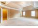 Spacious carpeted main bedroom with tray ceiling, chandelier, and bright natural light at 561 Ambergate Nw Pl, Concord, NC 28027