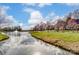 Scenic view of the community pond and walking trail, lined with trees in a residential neighborhood at 561 Ambergate Nw Pl, Concord, NC 28027