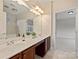 Bathroom featuring double sink vanity with large mirror and white tiling in shower/tub at 6042 Legacy Cir, Charlotte, NC 28277